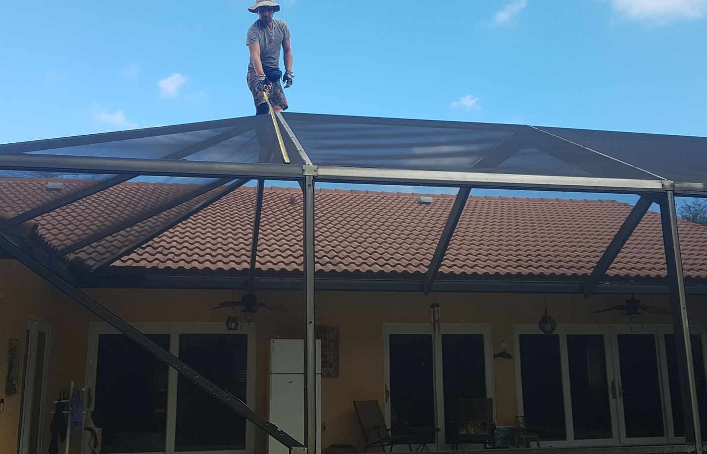 Pool cage roof screen repair in progress